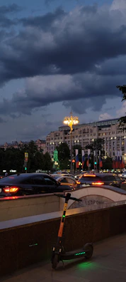 A serene evening cityscape with an Élancia VTC car waiting for a passenger.