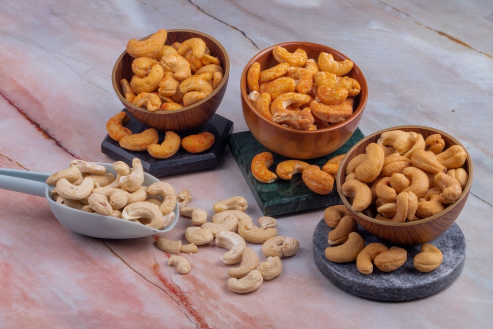 a table topped with bowls filled with cashews