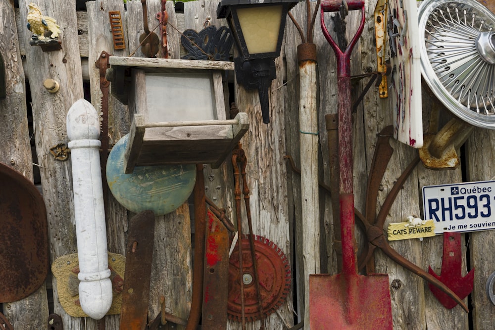 a wooden fence with a bunch of different items on it