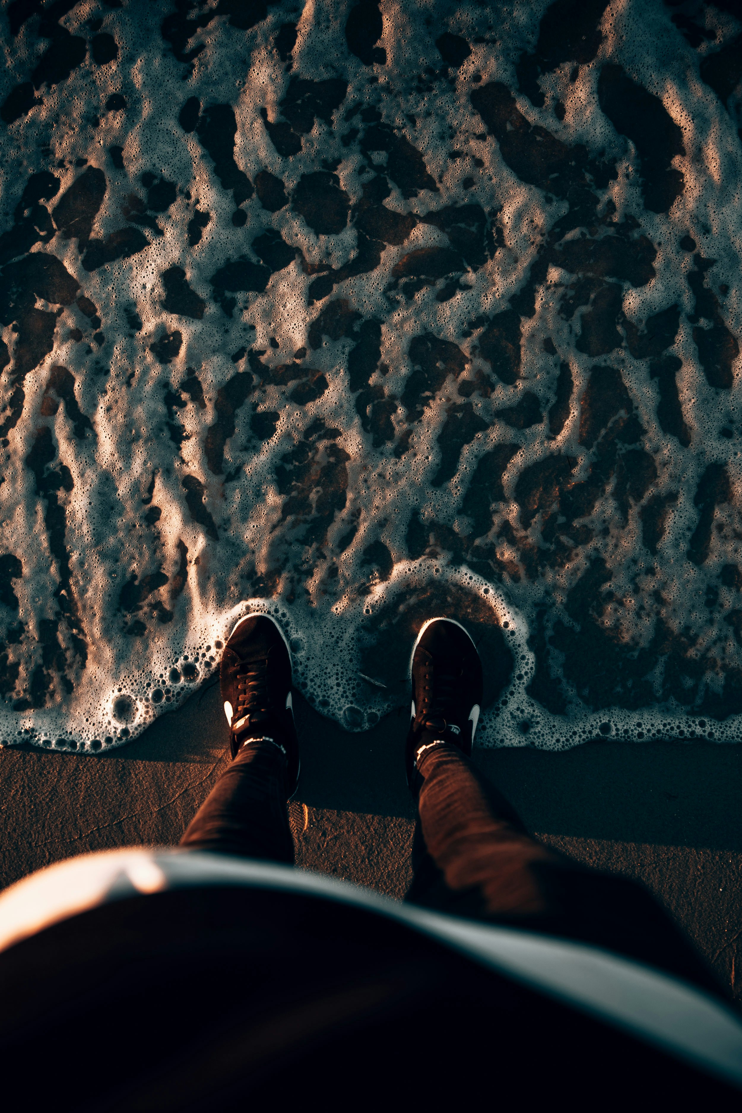a person standing on a beach next to the ocean