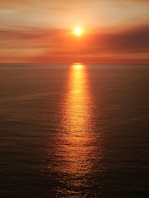 A vibrant sunset casting warm hues over the ocean.