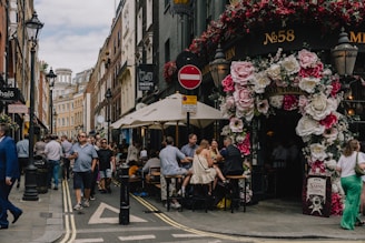 Modern commercial shops and cafes near the Florae complex with people enjoying the area.