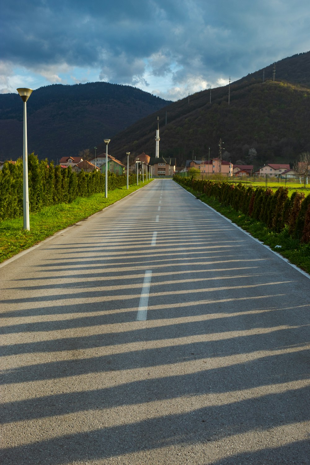 a long empty road in the middle of a field