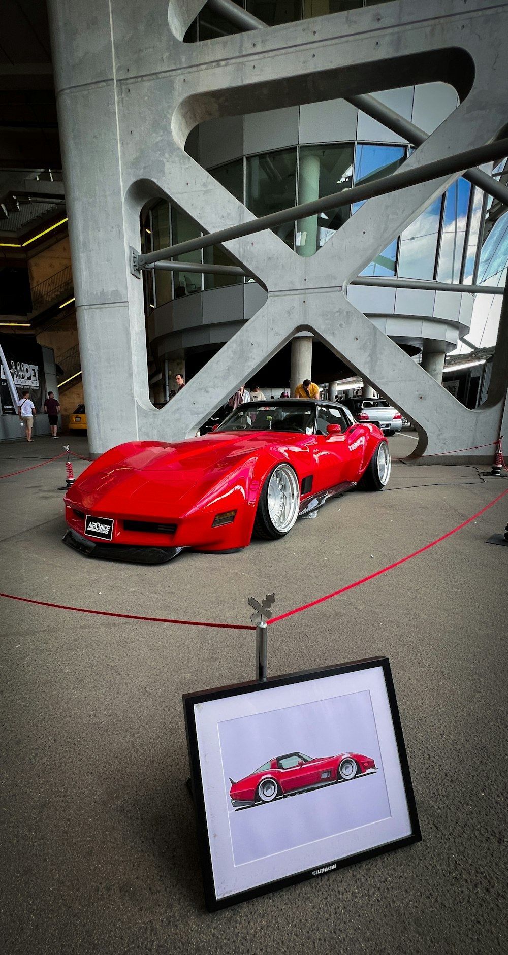 a red sports car is on display in a museum