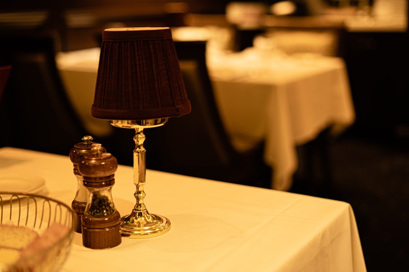 a table with a lamp and a basket on it