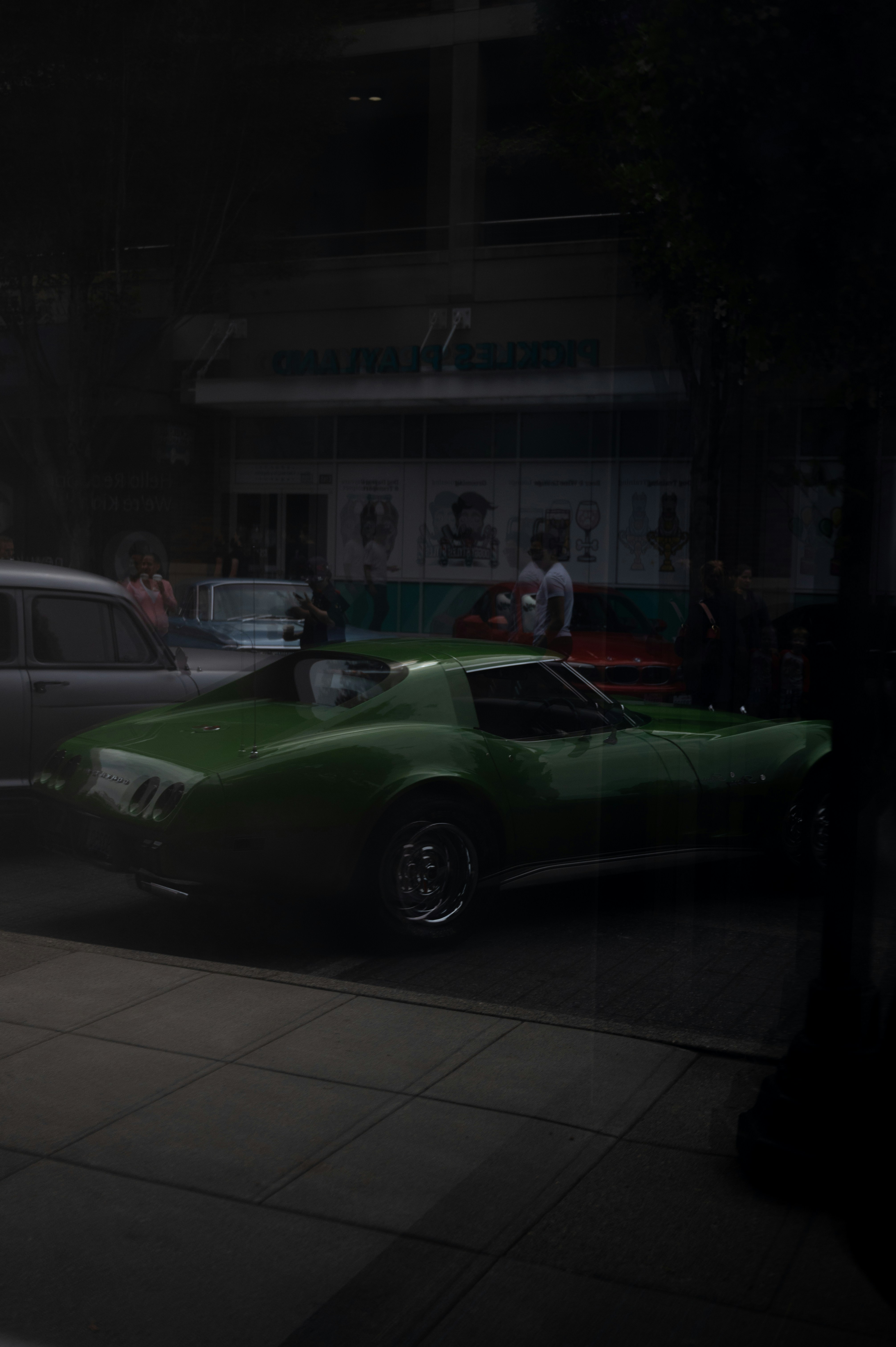 a green car parked on the side of the road