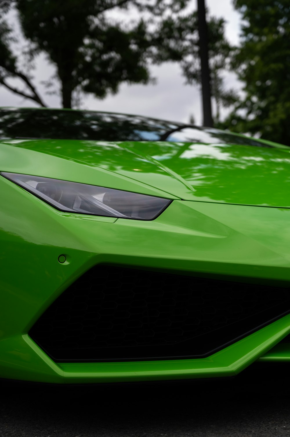 a green sports car parked on the side of the road