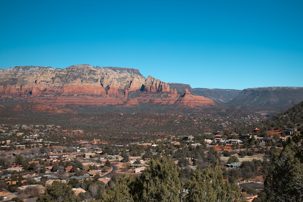 a scenic view of a town and mountains