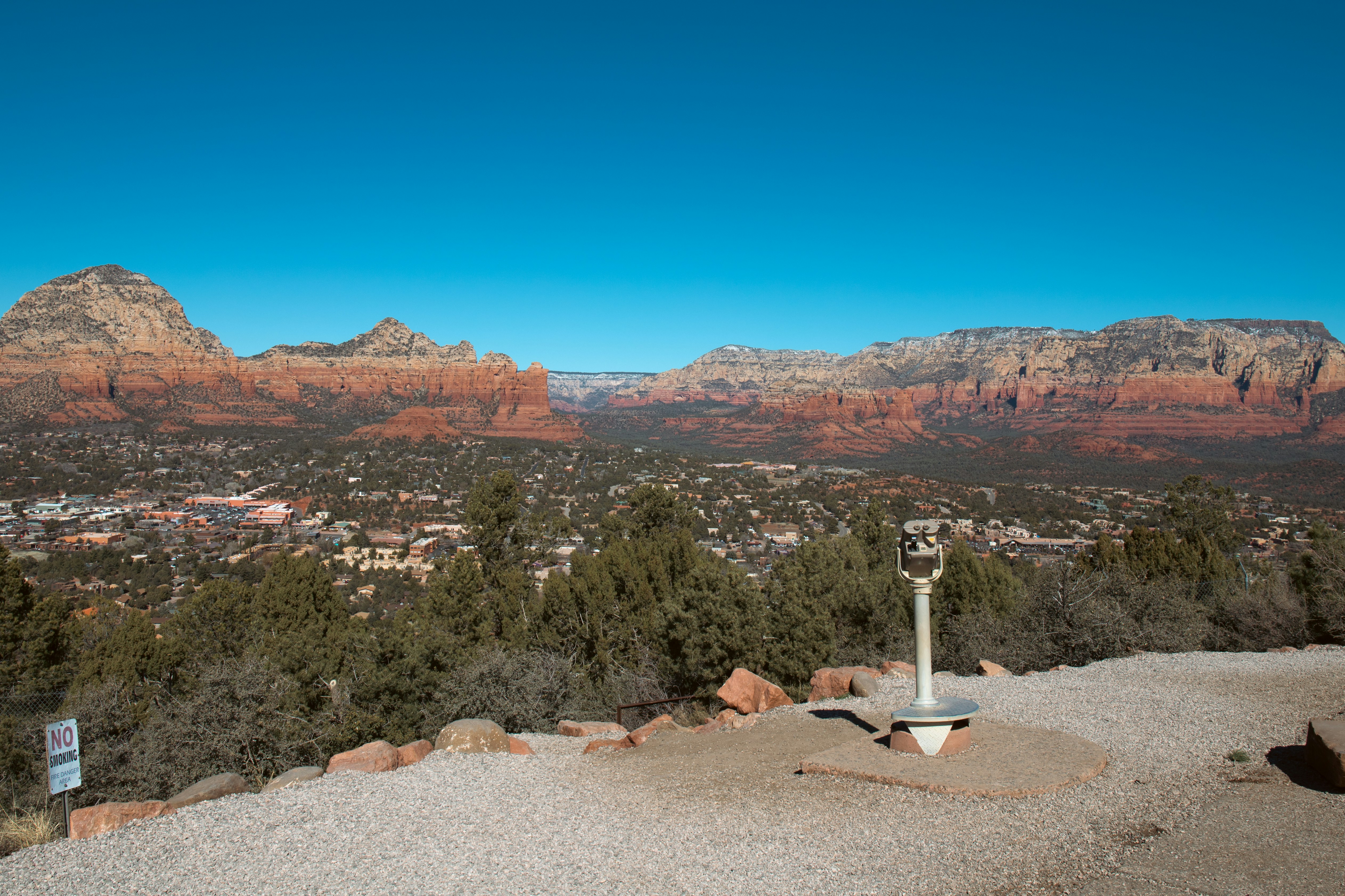 a view of a valley and mountains from the top of a hill
