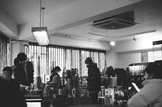 A diverse group of people smiling and interacting in a cozy café setting.