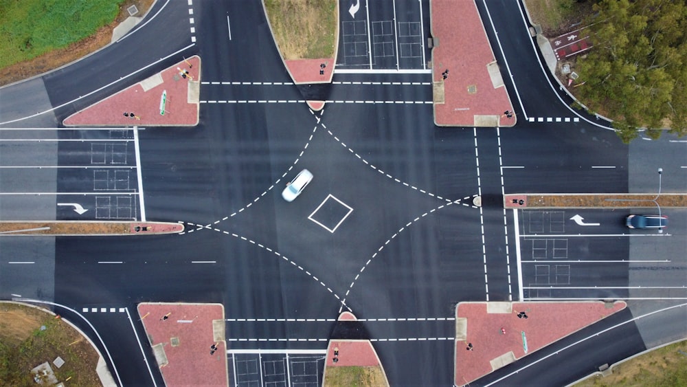 an aerial view of a parking lot with cars parked on it