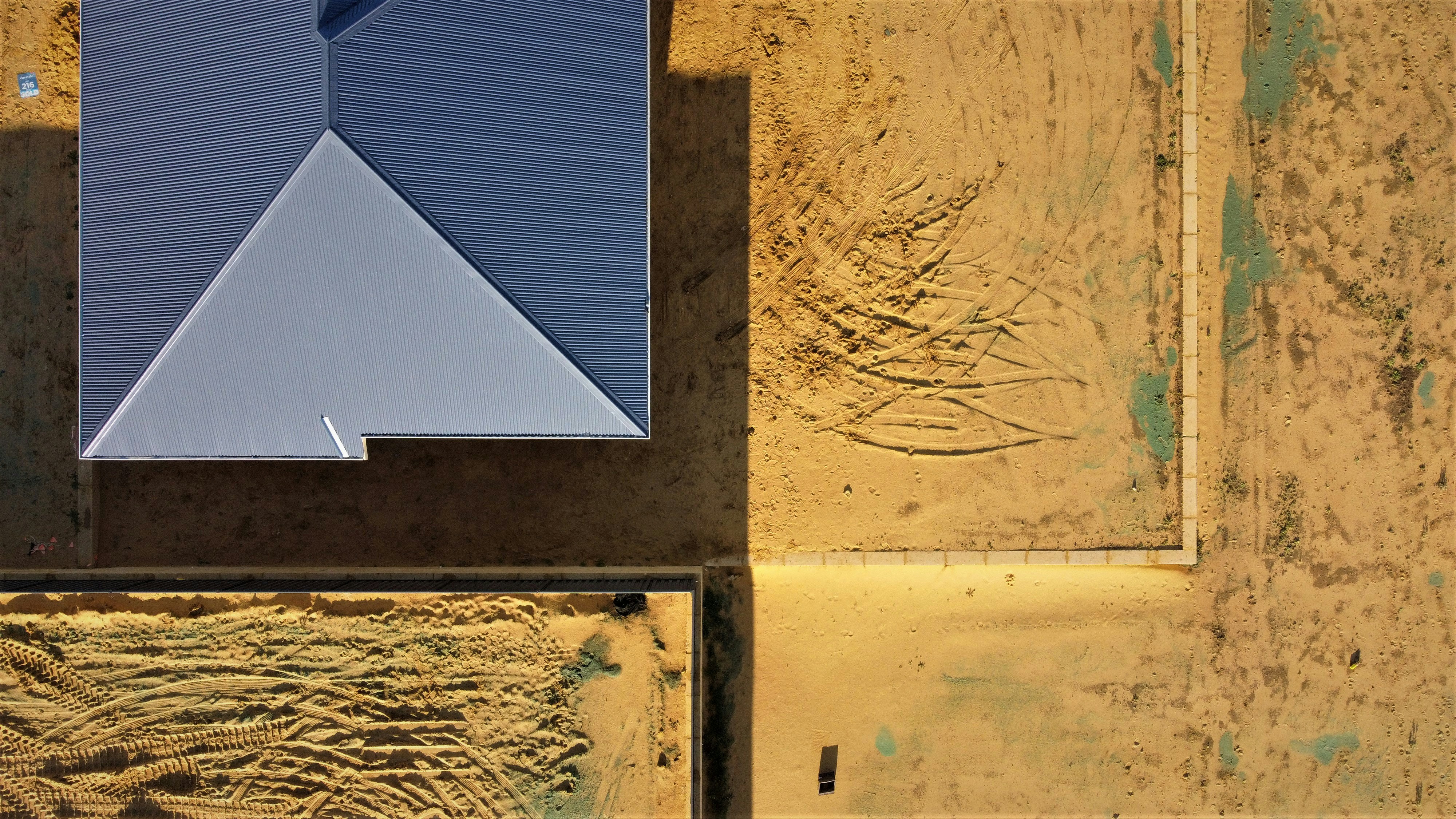an aerial view of a building with a blue roof