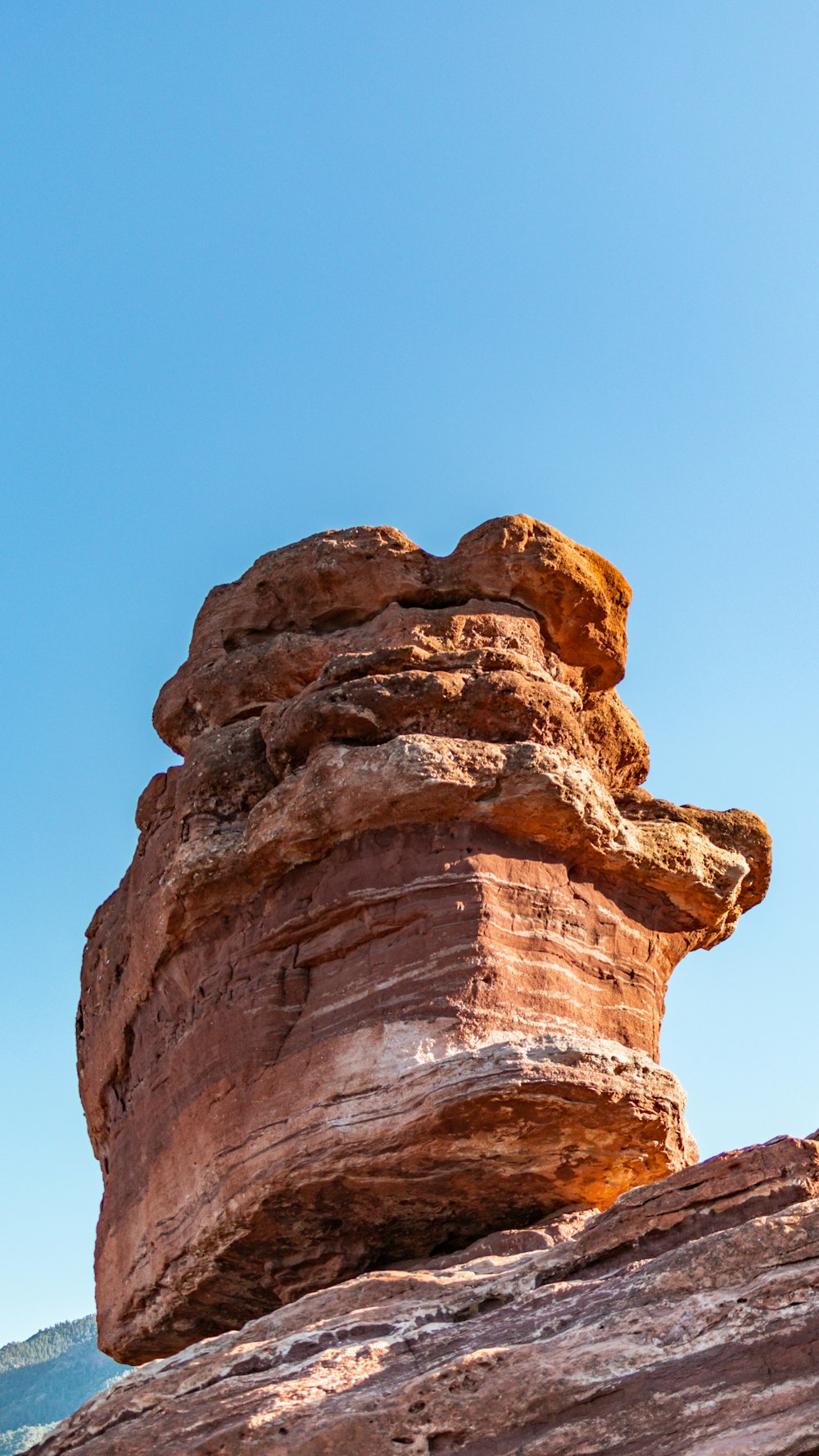 a rock formation in the desert against a blue sky