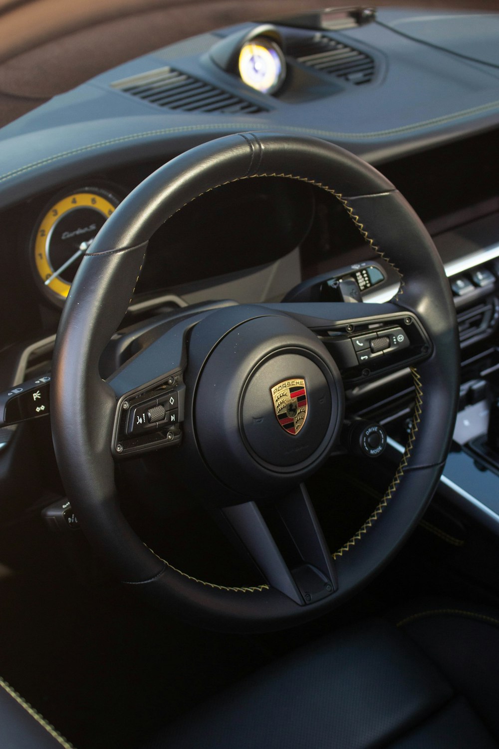 a steering wheel and dashboard of a sports car
