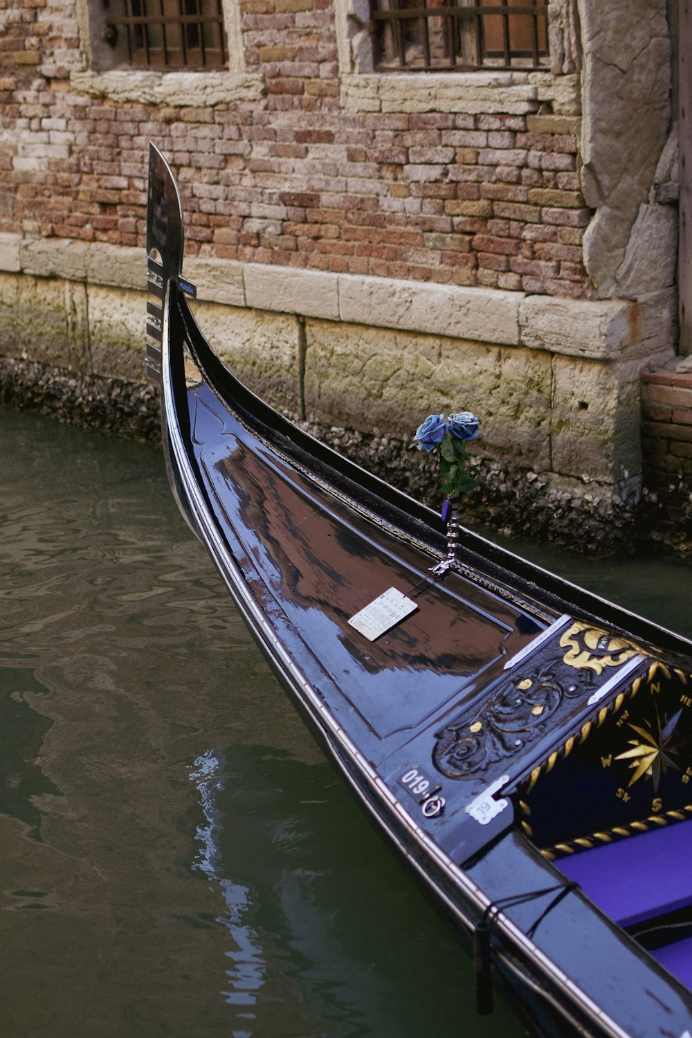 a gondola in a canal next to a brick building