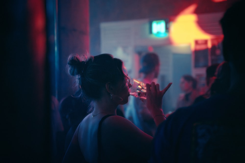 a woman smoking a cigarette in a dark room