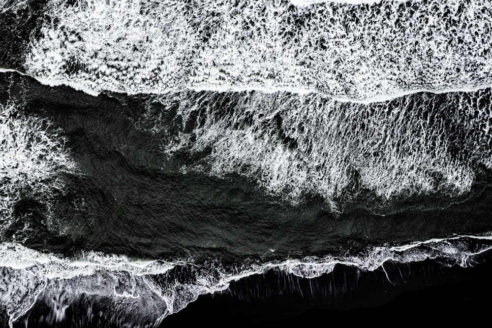 a black and white photo of the ocean waves