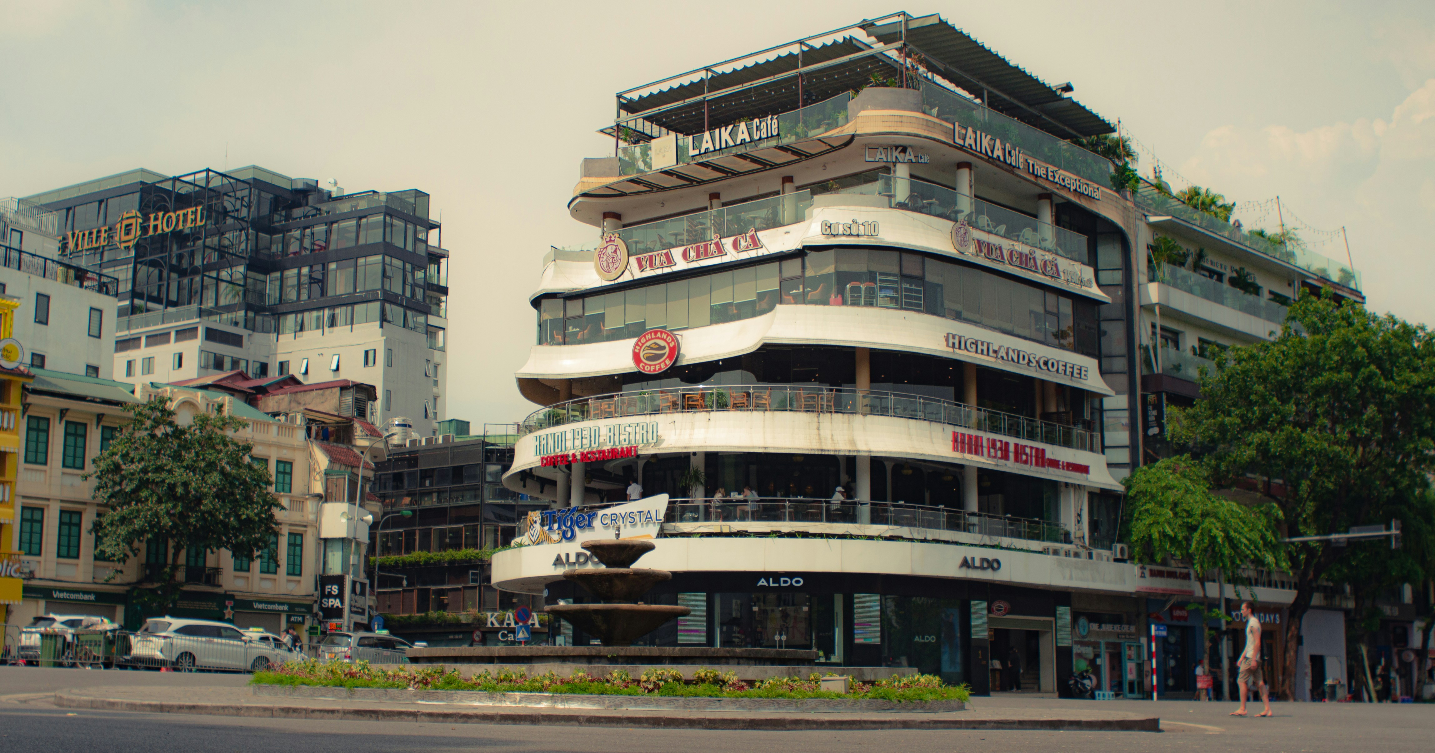a tall building with a fountain in front of it