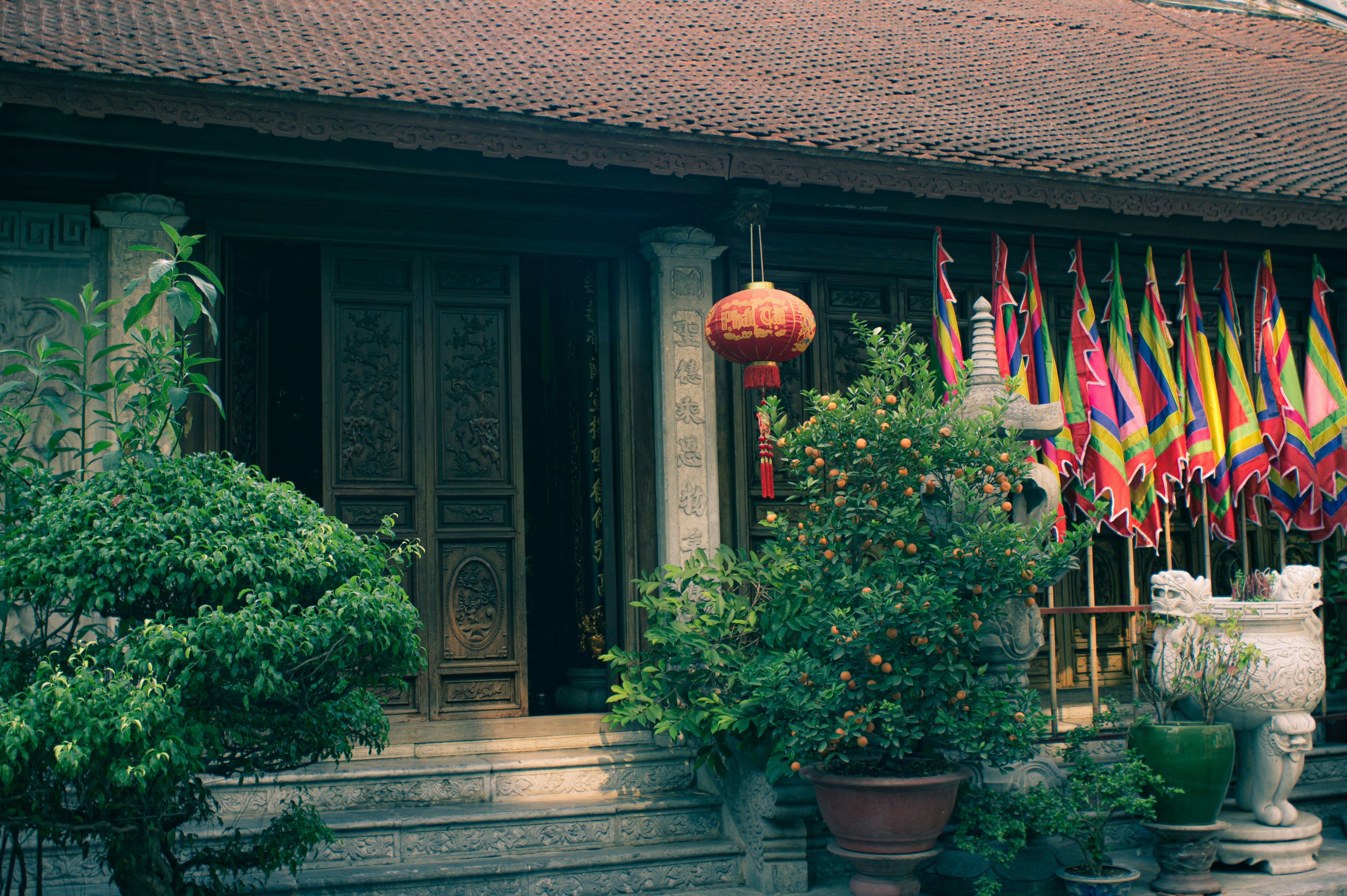 a building with a bunch of flags hanging from it's windows