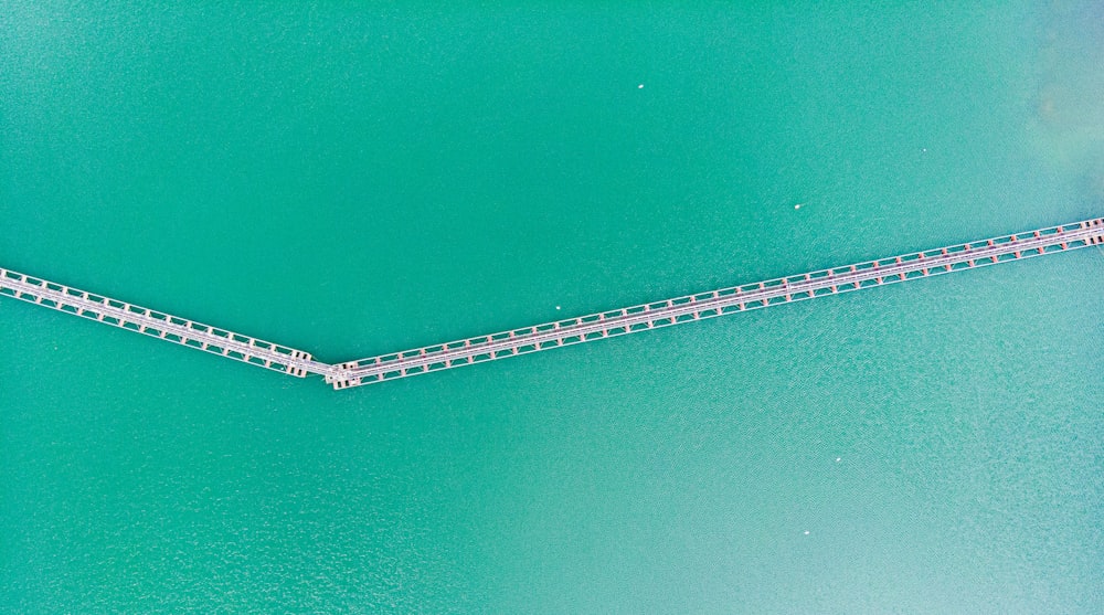 an aerial view of a bridge over a body of water