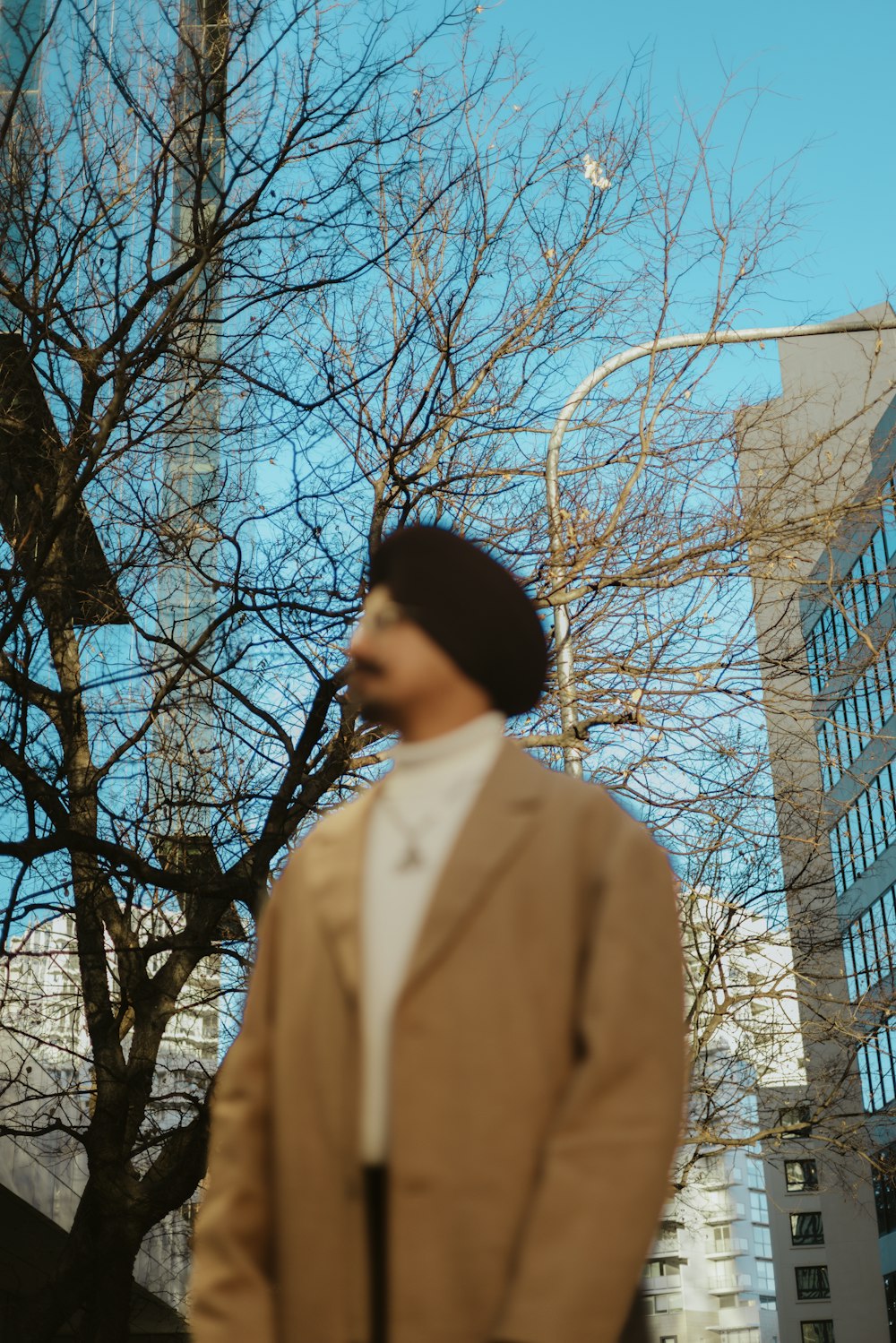 a man in a brown jacket and a brown hat