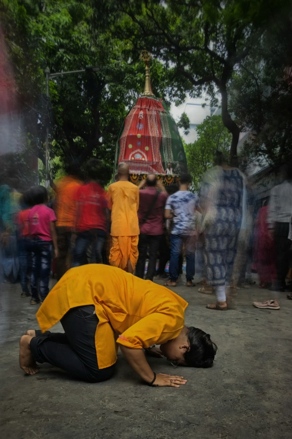 a man in a yellow shirt kneeling on the ground