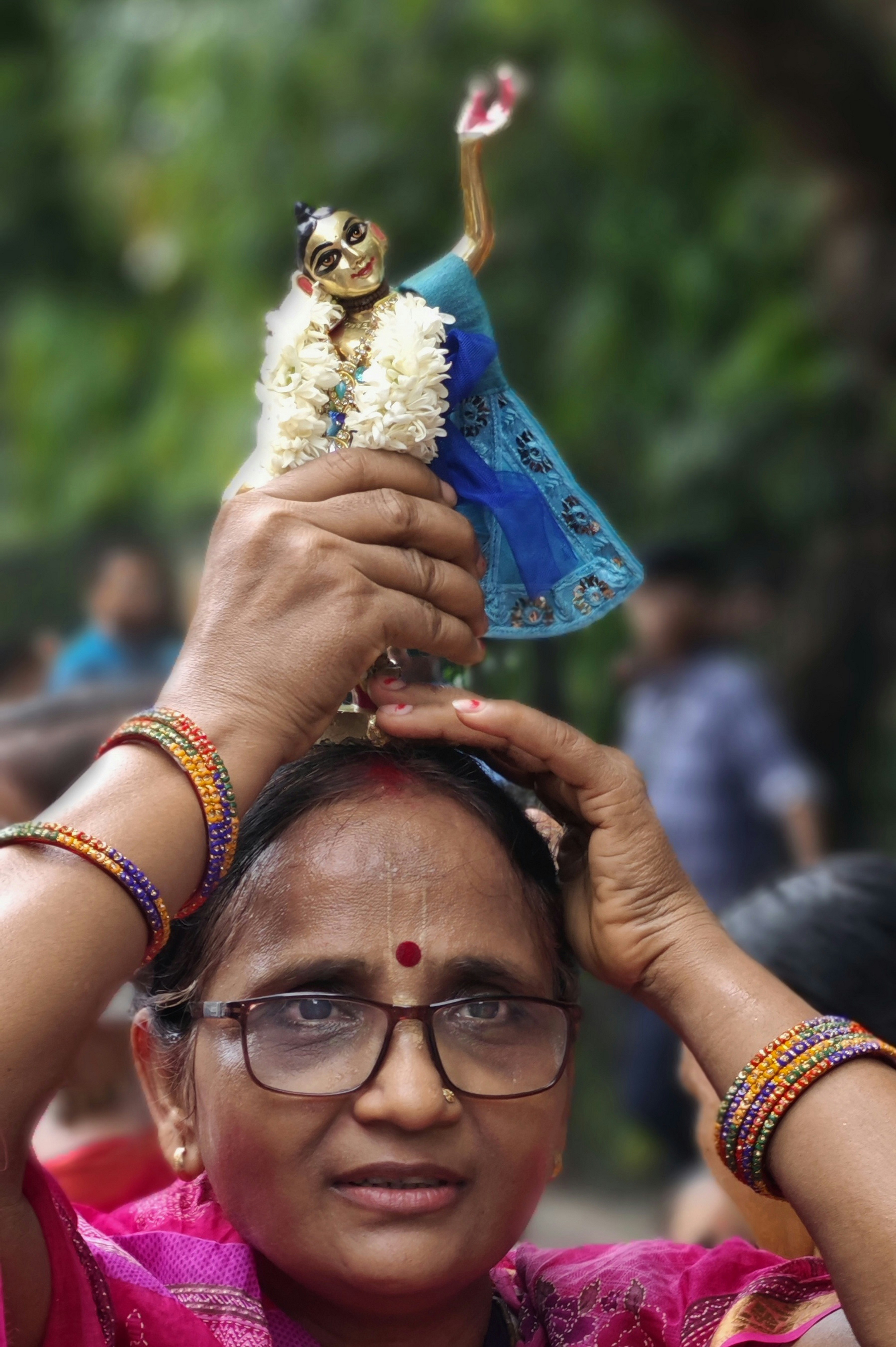 a woman is holding a doll in her hand
