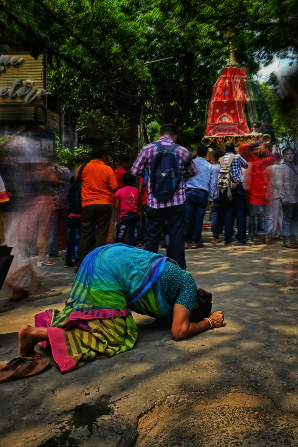 a woman laying on the ground in front of a crowd of people