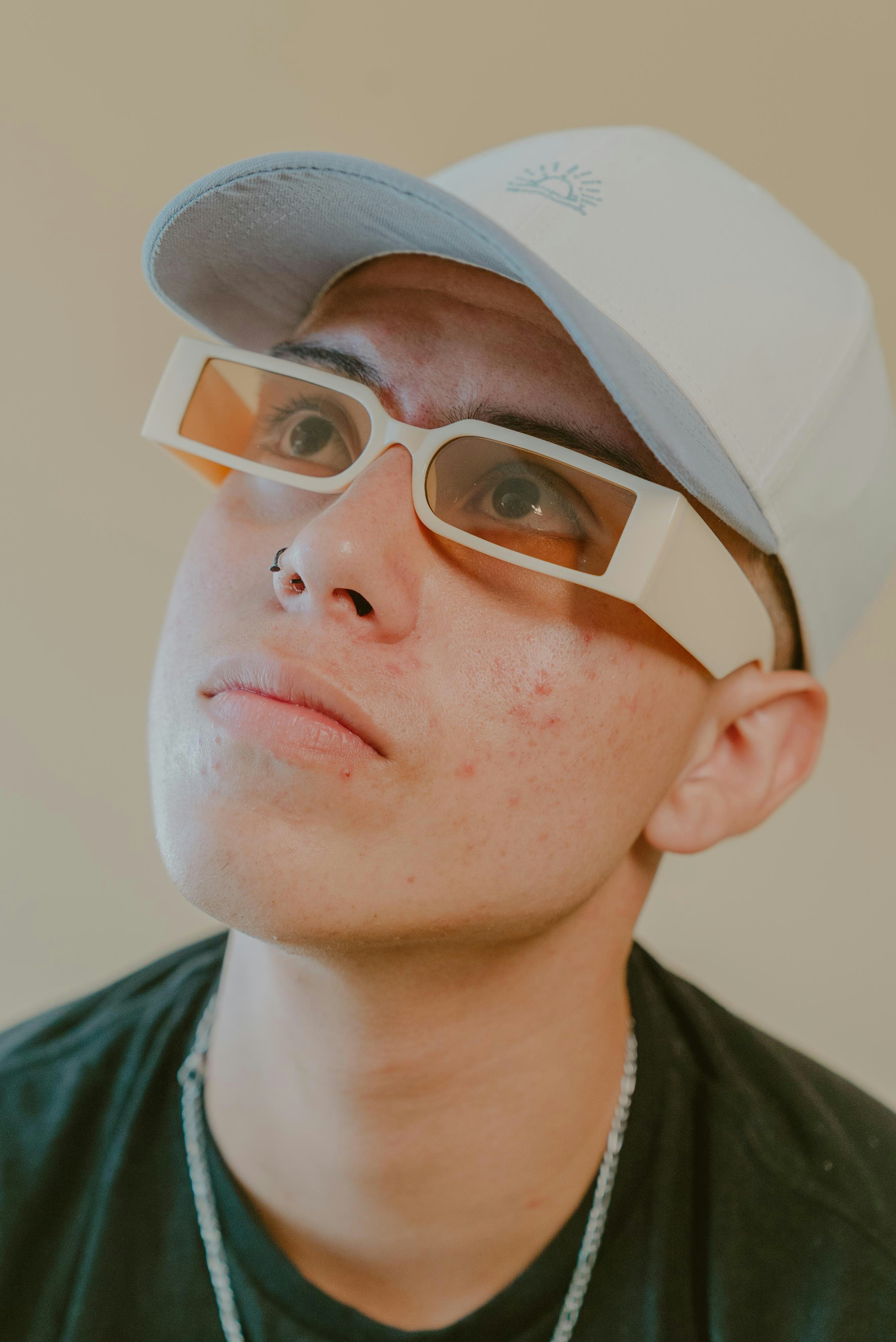 a man wearing a white hat and glasses