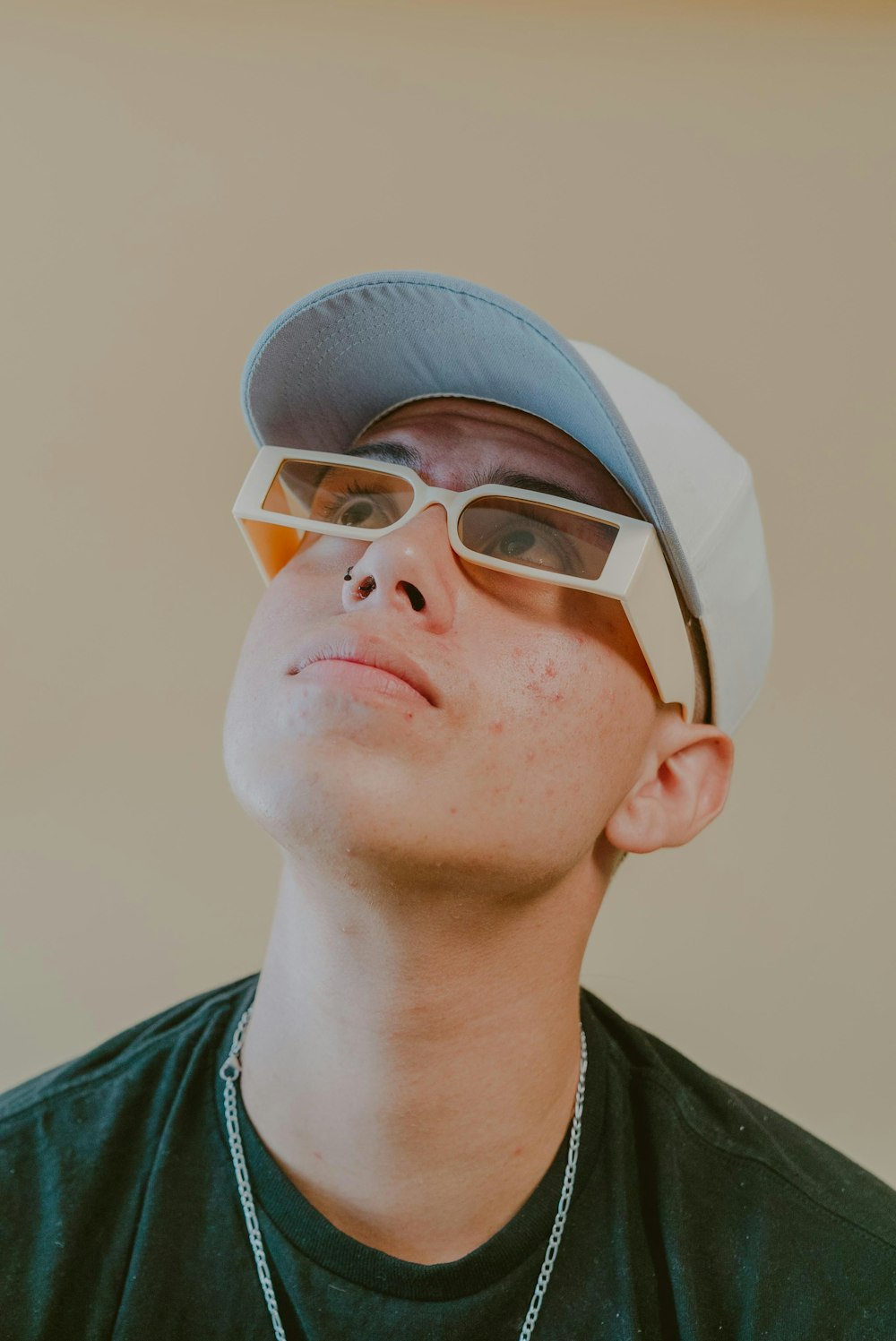 a man wearing sunglasses and a baseball cap