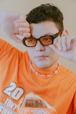Model wearing a bright orange custom t-shirt with personalized graphic.