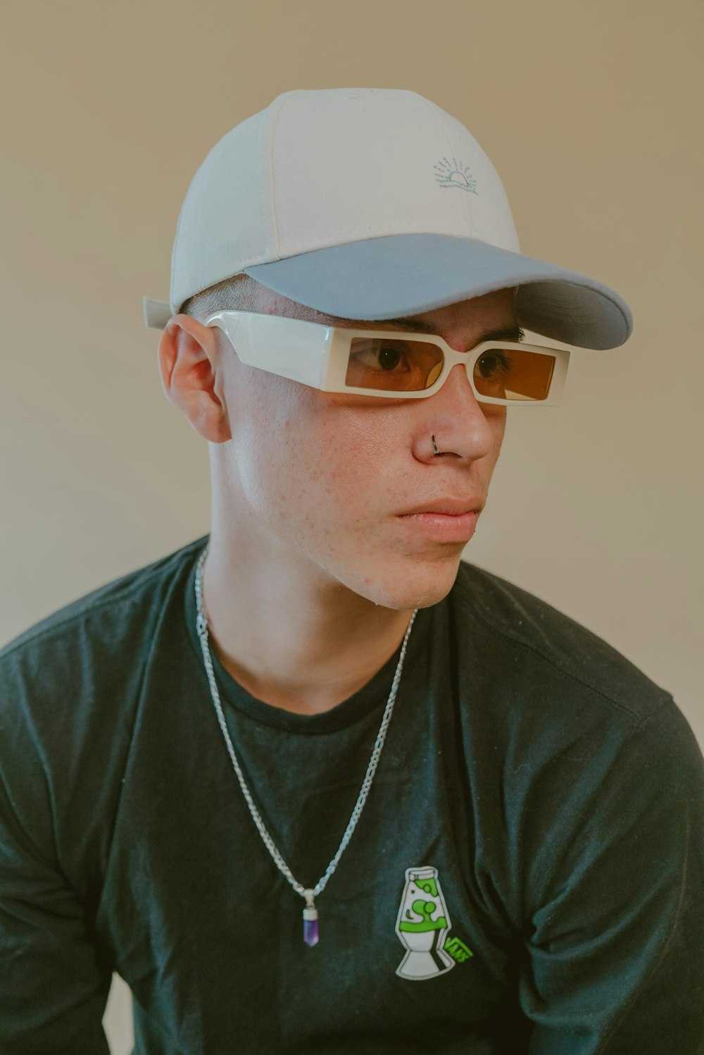 a man wearing a baseball cap and sunglasses