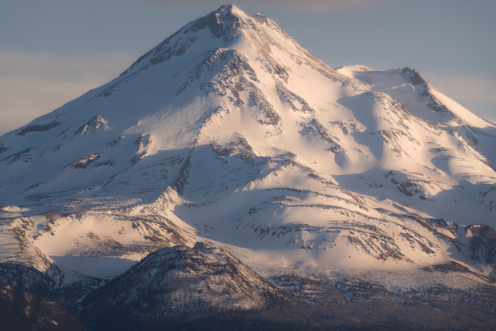 a large snow covered mountain in the middle of the day