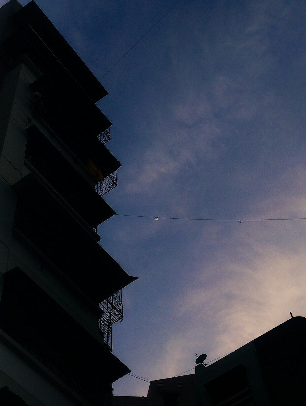 a tall building with a sky in the background