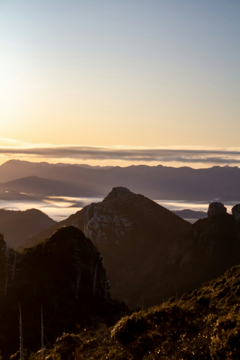 a person standing on top of a mountain with a sky background