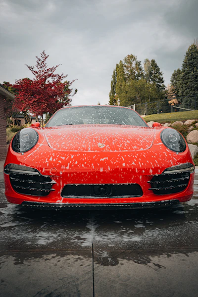 a red sports car parked in a driveway