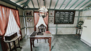 Detail of the room’s handcrafted wooden desk with a vintage writing set.