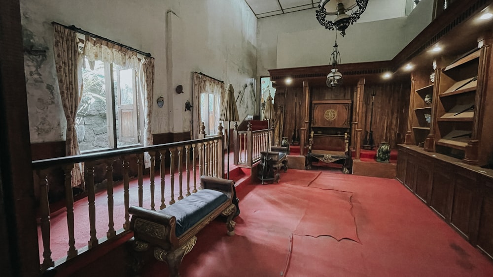 a large room with a red carpet and wooden walls