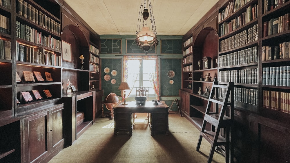 a room filled with lots of books and a ladder