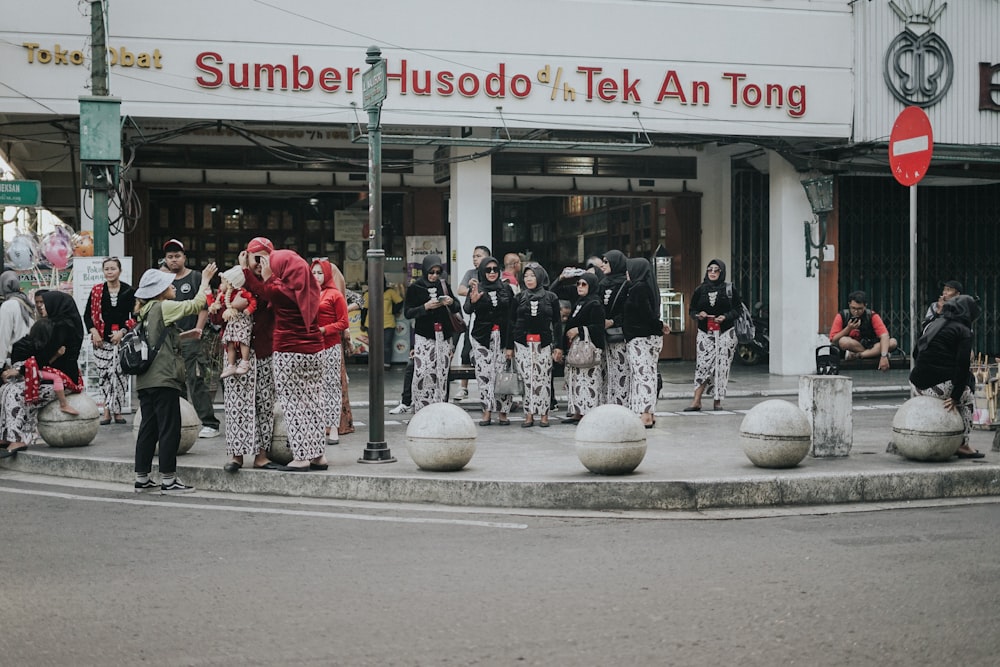 a group of people standing on the side of a road