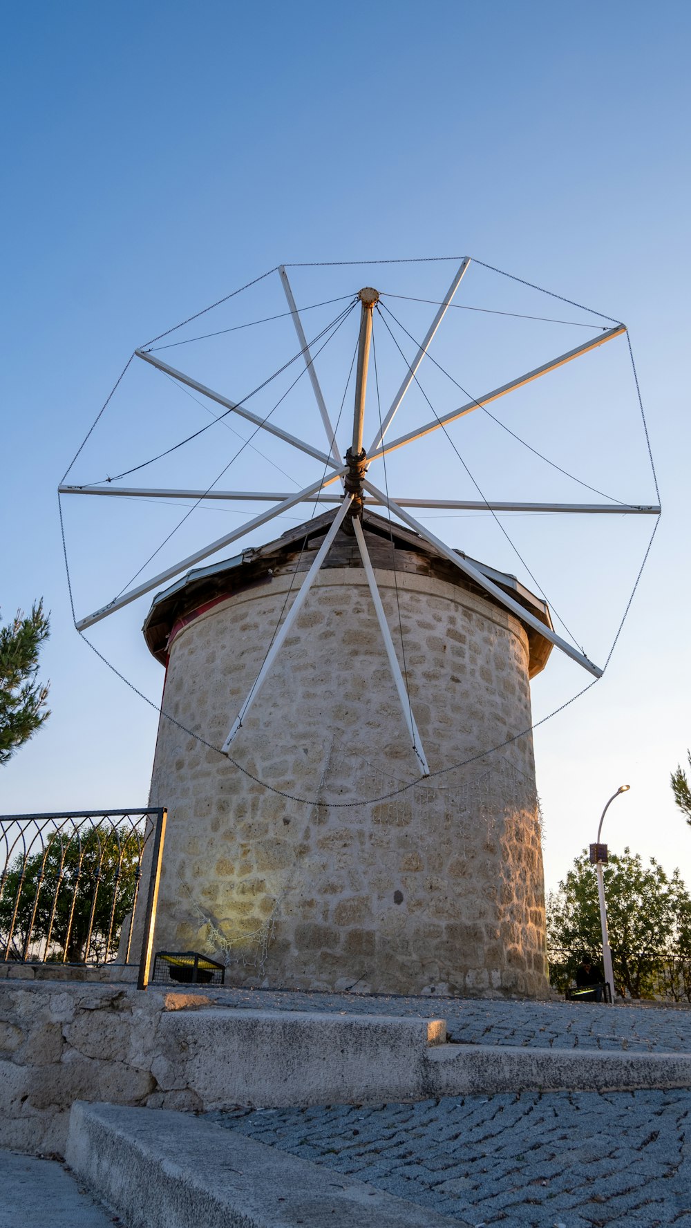 a windmill sitting on top of a stone hill