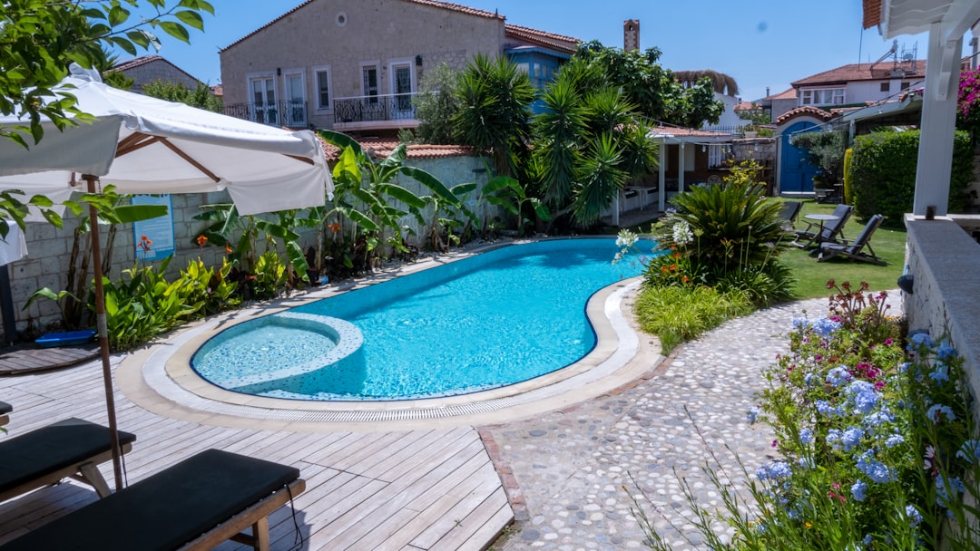 a backyard with a swimming pool surrounded by greenery, Butik otelde büyük bir havuz. Big pool in boutique hotel.