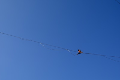 Close-up of a young performer balancing on a tightrope with focused determination.