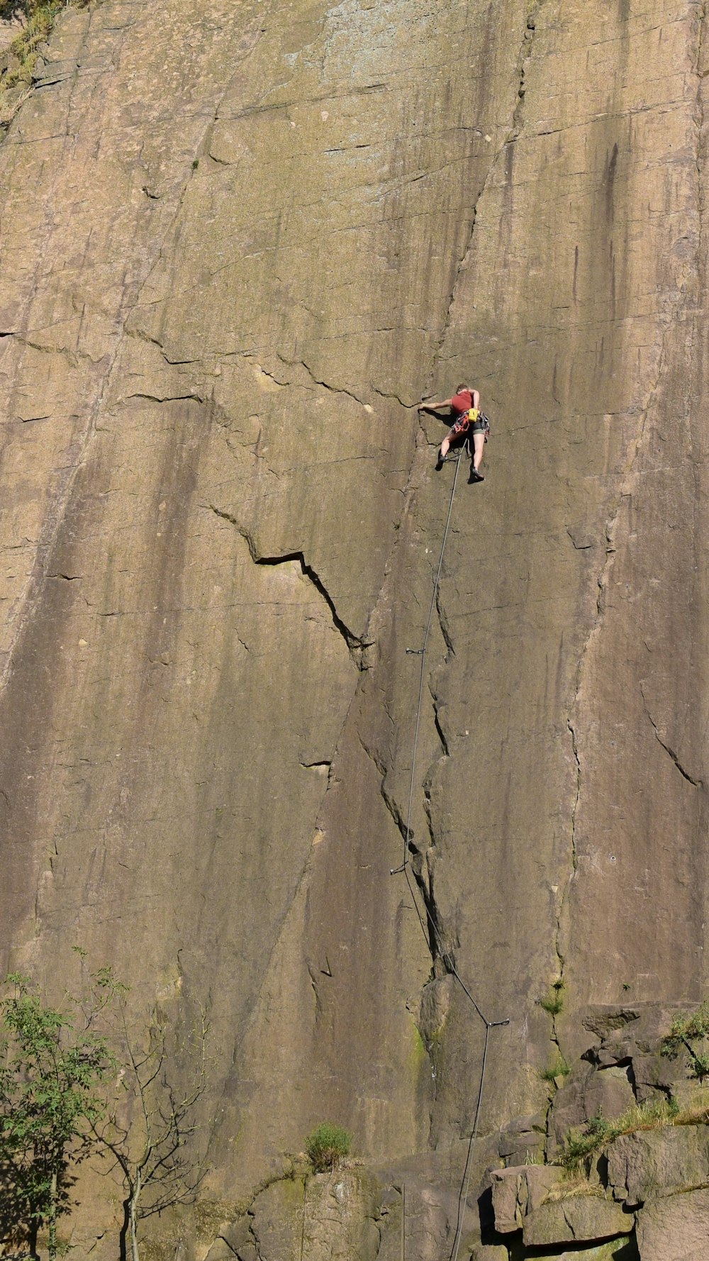 a man climbing up the side of a cliff