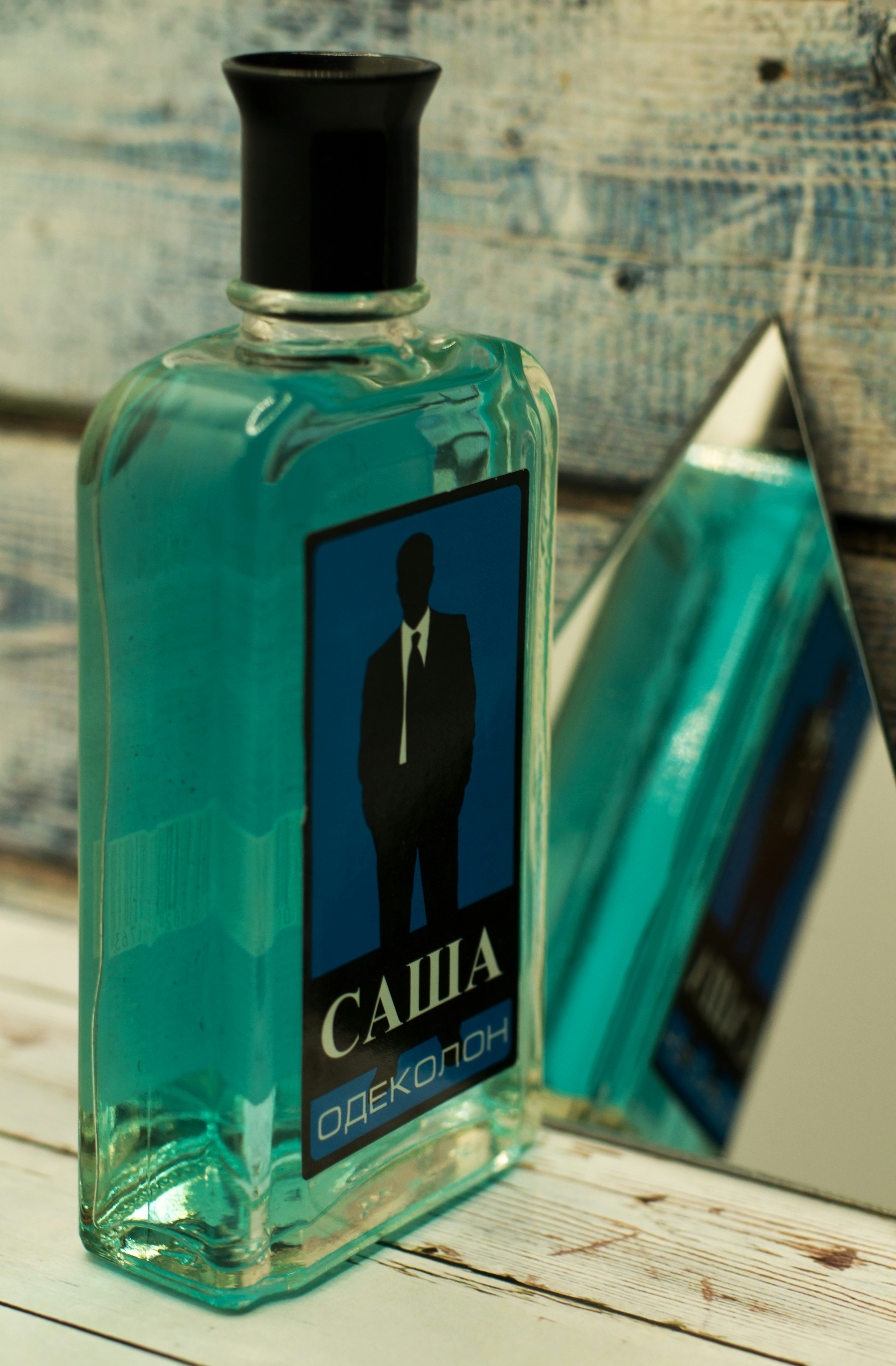 a bottle of cologne sitting on top of a wooden table