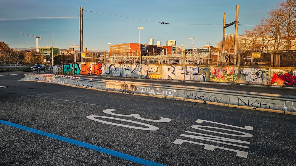 a street with a lot of graffiti on the side of it