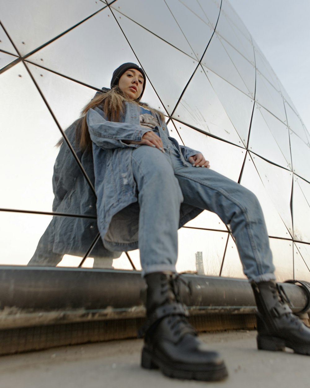 a woman sitting on top of a metal structure