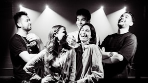 A group of helpers sharing a light moment during a break, reflecting the friendly team spirit.