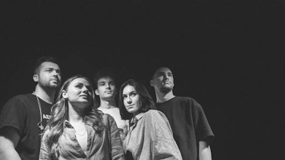 Close-up of the main cast gathered around a crime scene, faces filled with determination.