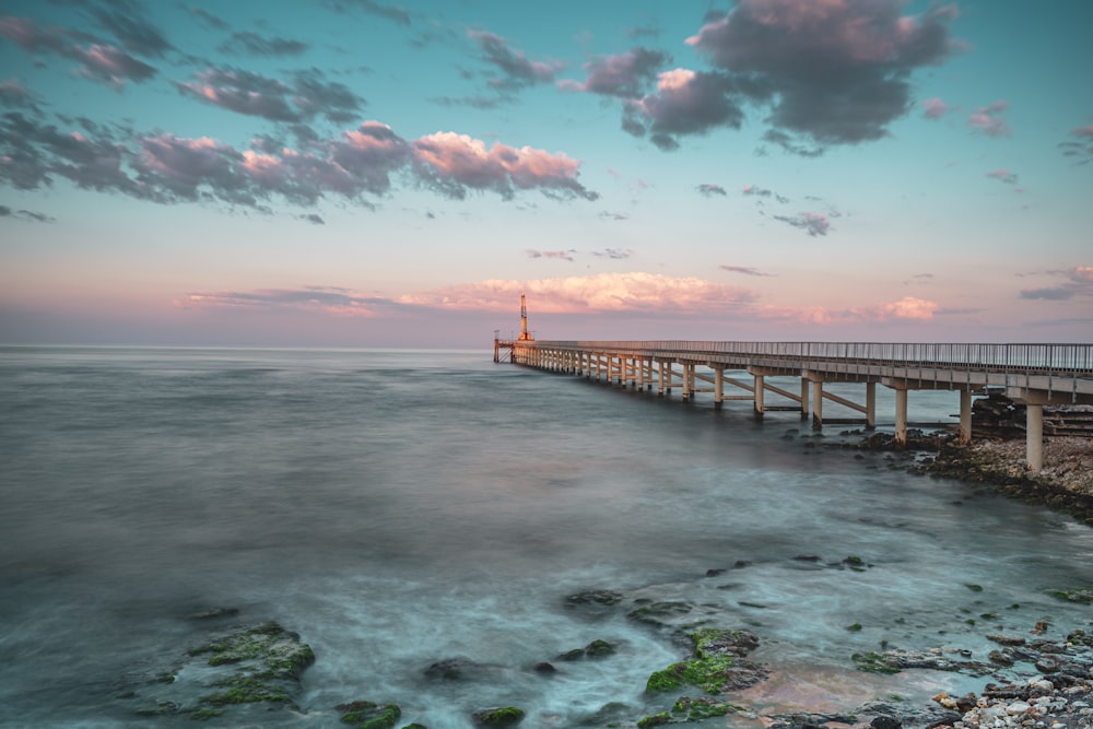 a long pier stretching out into the ocean